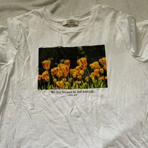 “We love because He first loved us” Tee